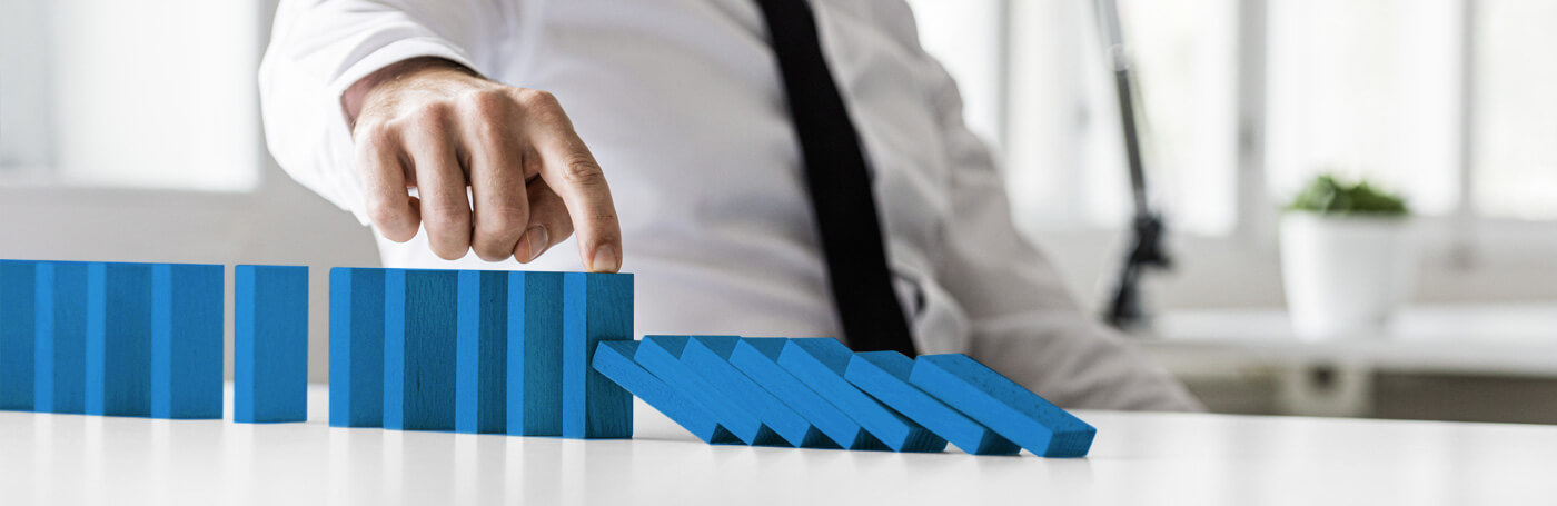 Business continuity featured image of man with dominos