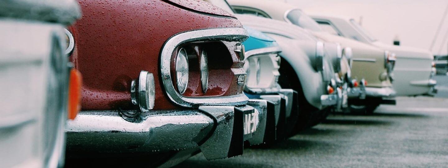 Featured image of vintage cars lined up at an outside show room