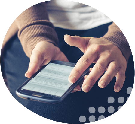 Photo of person holding and looking at mobile