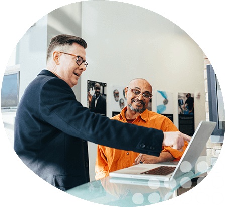 Photo of two guys speaking and showing one another how to do business